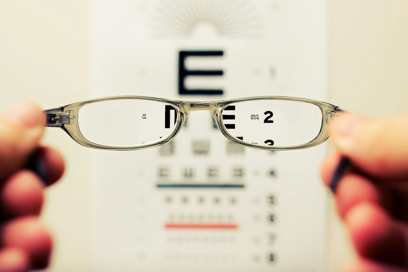Looking through eyeglasses at an eye chart coming into focus